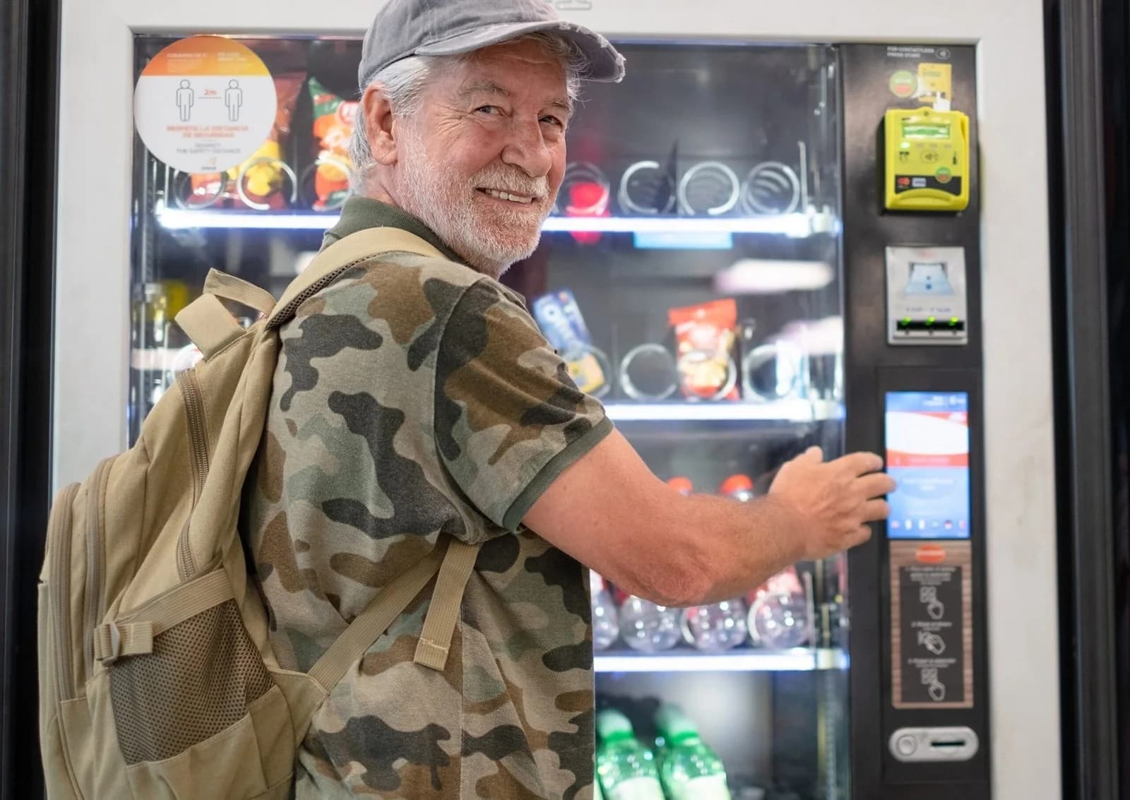 A smiling man choosing a drink